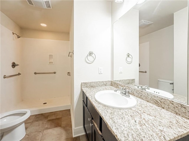 bathroom with vanity, a shower, a bidet, tile patterned floors, and toilet