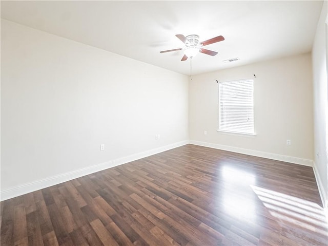 empty room featuring dark hardwood / wood-style flooring and ceiling fan