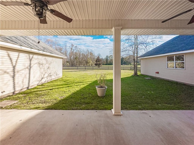 view of yard featuring ceiling fan and a patio