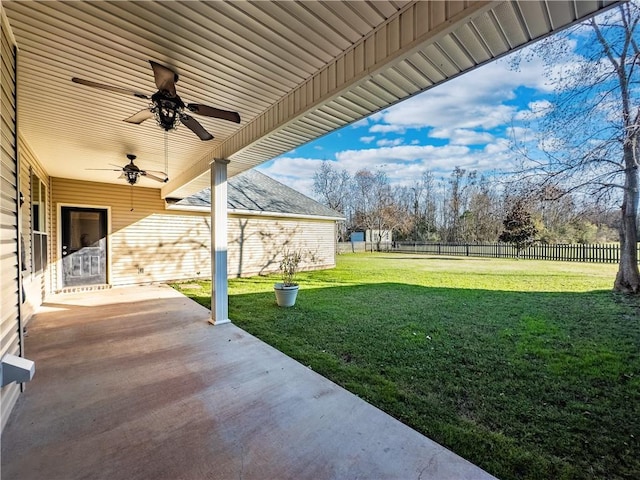 view of yard with ceiling fan and a patio