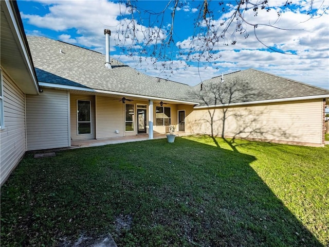 rear view of house featuring a lawn and a patio area