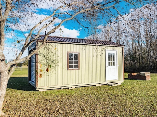 view of outdoor structure with a lawn