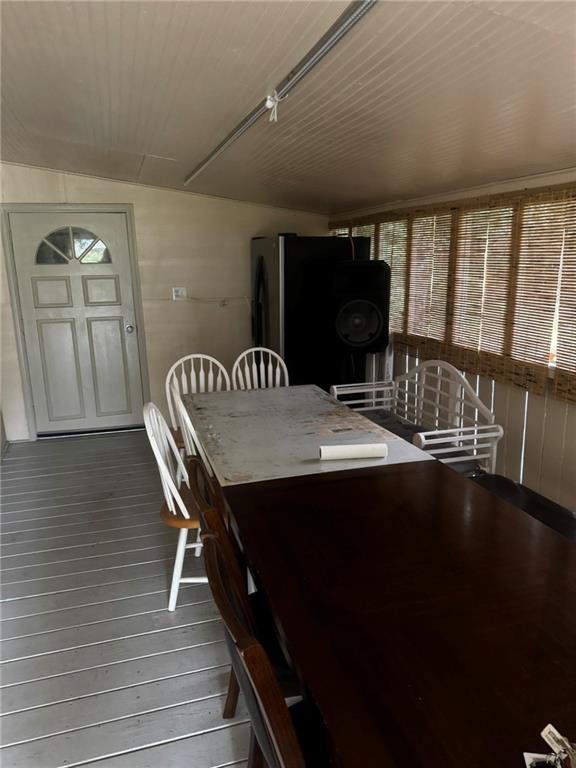 unfurnished dining area with hardwood / wood-style floors and lofted ceiling