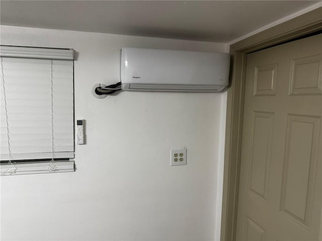 laundry area with a wall unit AC