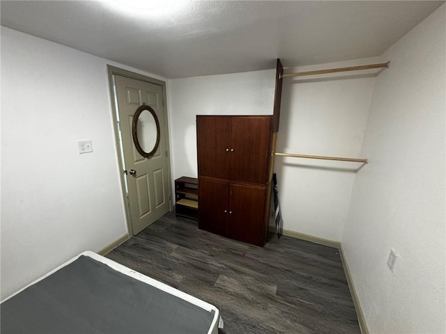 bedroom with dark hardwood / wood-style flooring