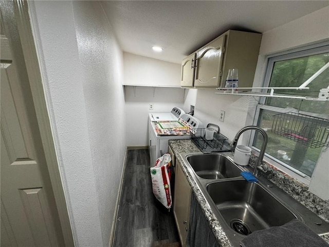 kitchen featuring washer and dryer, dark wood-type flooring, and sink