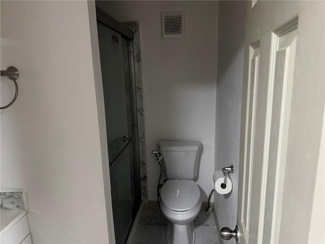 bathroom with vanity, an enclosed shower, and toilet