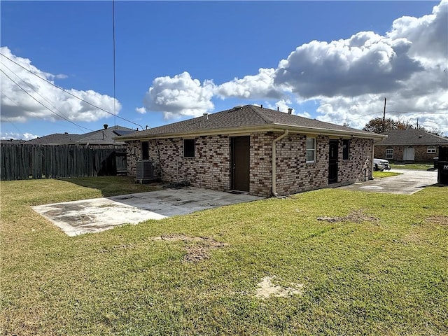 view of home's exterior with a lawn, a patio area, and central AC unit