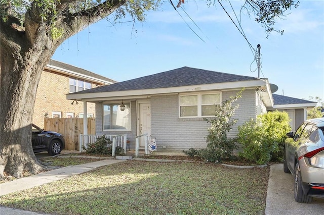 bungalow-style house featuring a front lawn