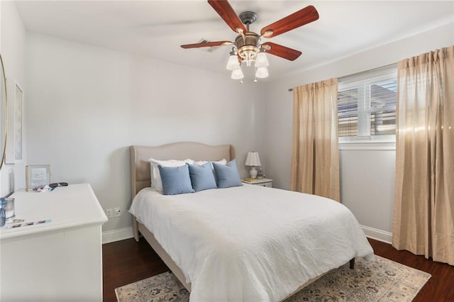 bedroom with ceiling fan and dark hardwood / wood-style flooring