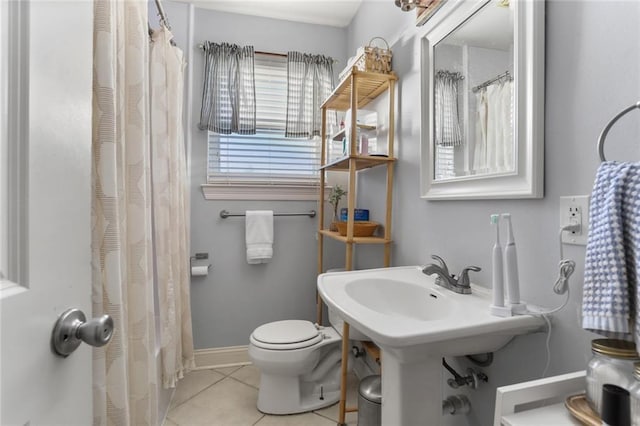 bathroom with tile patterned flooring and toilet