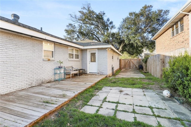 rear view of property featuring a wooden deck