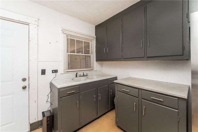 kitchen with tile walls, light countertops, and a sink