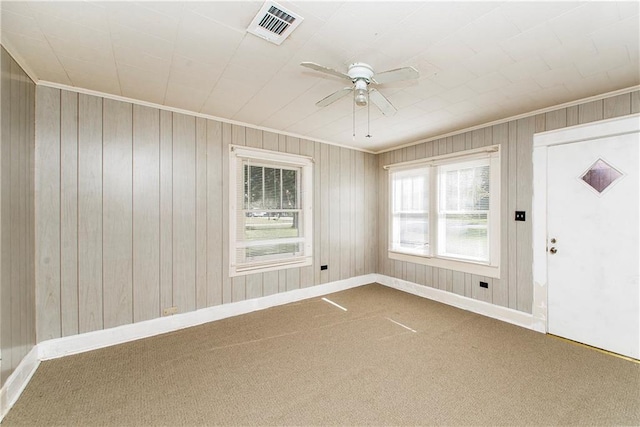 spare room featuring visible vents, baseboards, carpet, and ceiling fan