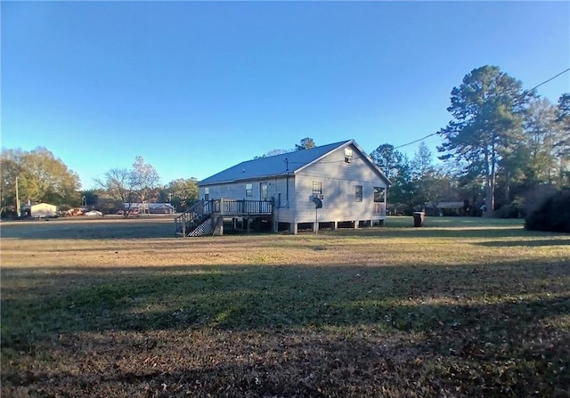 view of property exterior featuring a yard and a wooden deck