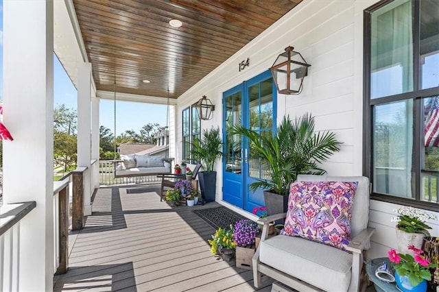 sunroom / solarium featuring wood ceiling