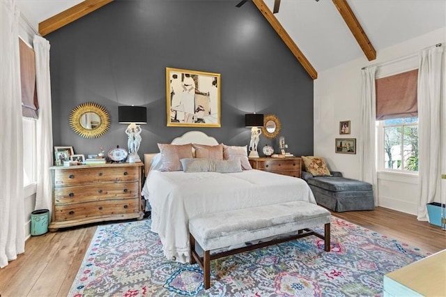 bedroom with light hardwood / wood-style flooring, beamed ceiling, and high vaulted ceiling