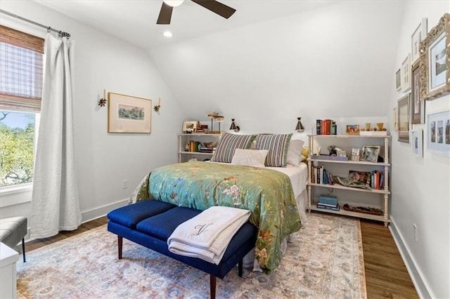 bedroom featuring multiple windows, wood-type flooring, vaulted ceiling, and ceiling fan