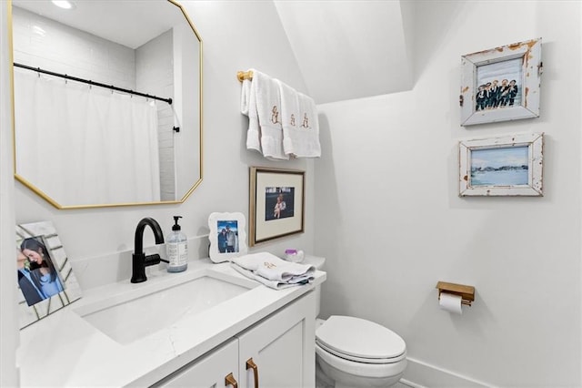 bathroom featuring walk in shower, vanity, and toilet