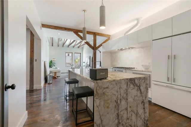 301 S Toulme St Unit 108, Bay Saint Louis, MS 39520 - living area featuring lofted ceiling with beams and dark hardwood / wood-style floors