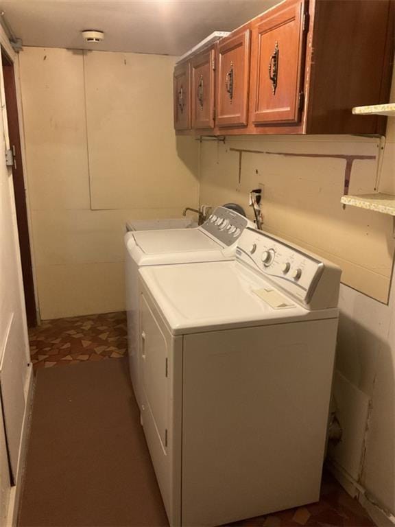 laundry area featuring washer and dryer and cabinets