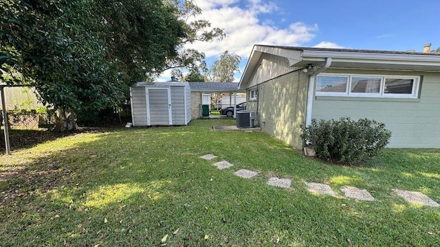 view of yard featuring central AC and a shed