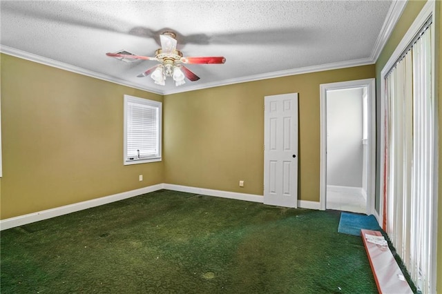 unfurnished bedroom featuring ceiling fan, dark carpet, ornamental molding, and a textured ceiling