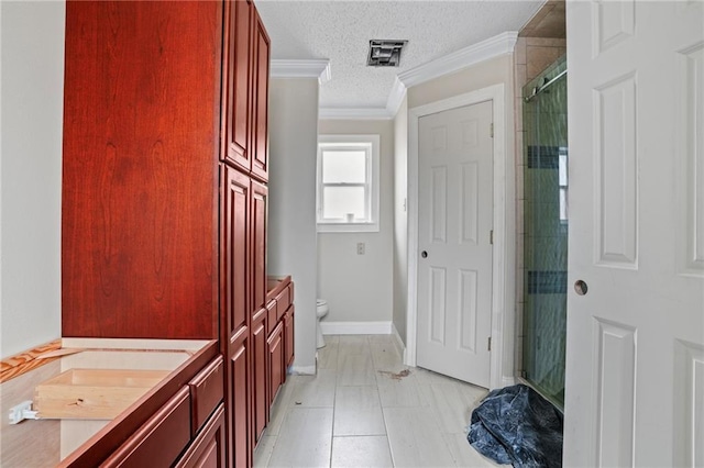 bathroom featuring vanity, tile patterned floors, toilet, a textured ceiling, and a shower with shower door