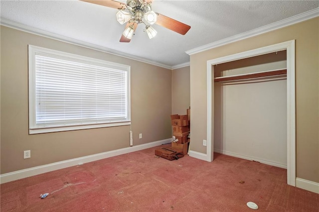 unfurnished bedroom with light carpet, a textured ceiling, ceiling fan, crown molding, and a closet