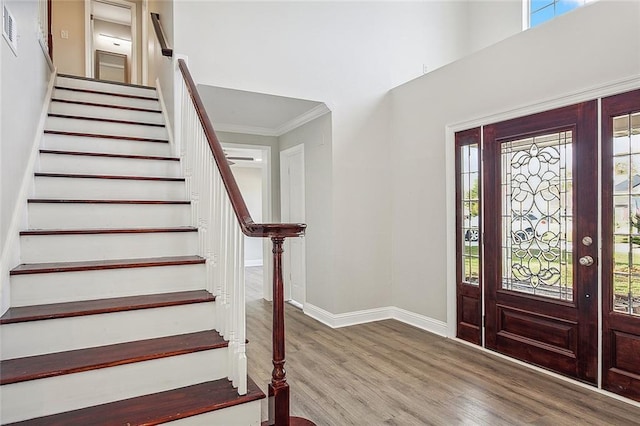 foyer featuring hardwood / wood-style floors and crown molding