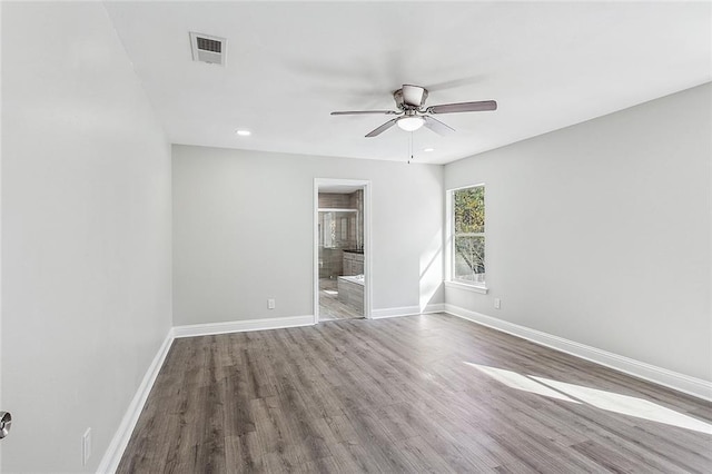 empty room with hardwood / wood-style floors and ceiling fan