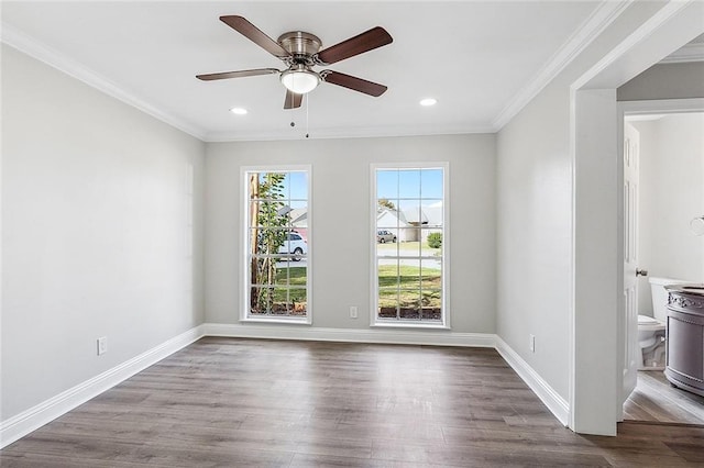 unfurnished room featuring dark hardwood / wood-style floors, ceiling fan, and crown molding