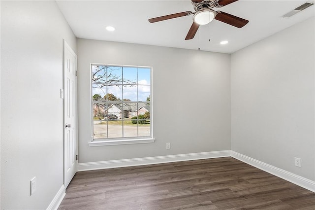 empty room with dark hardwood / wood-style flooring and ceiling fan