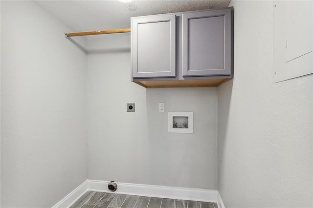 washroom featuring electric dryer hookup, electric panel, hookup for a washing machine, and cabinets