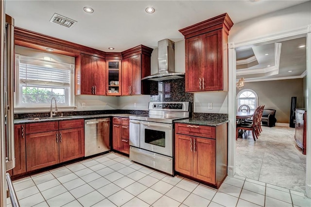 kitchen featuring appliances with stainless steel finishes, plenty of natural light, wall chimney exhaust hood, and sink