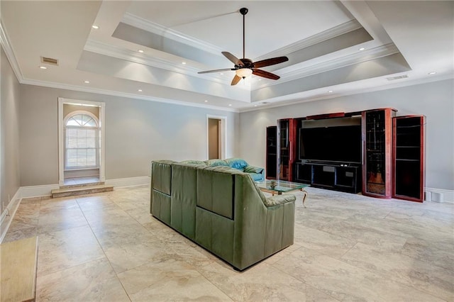 living room with ceiling fan, a raised ceiling, and crown molding