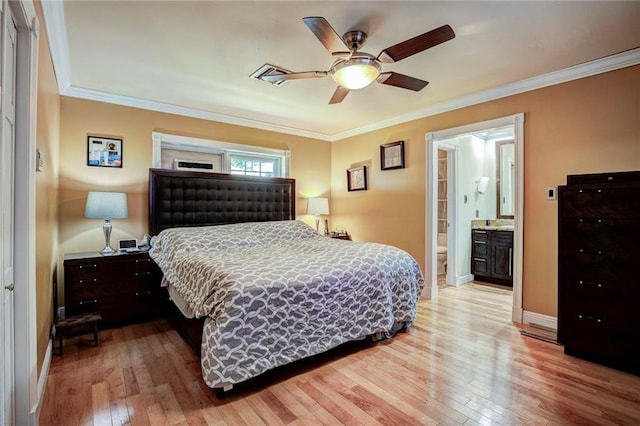 bedroom featuring ceiling fan, ensuite bathroom, light wood-type flooring, and crown molding