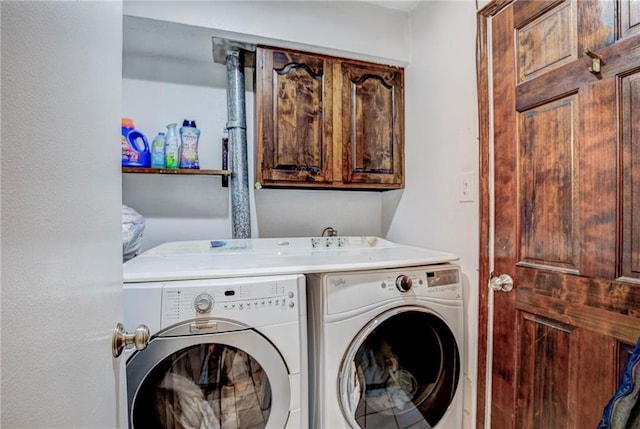 laundry area with cabinets and separate washer and dryer