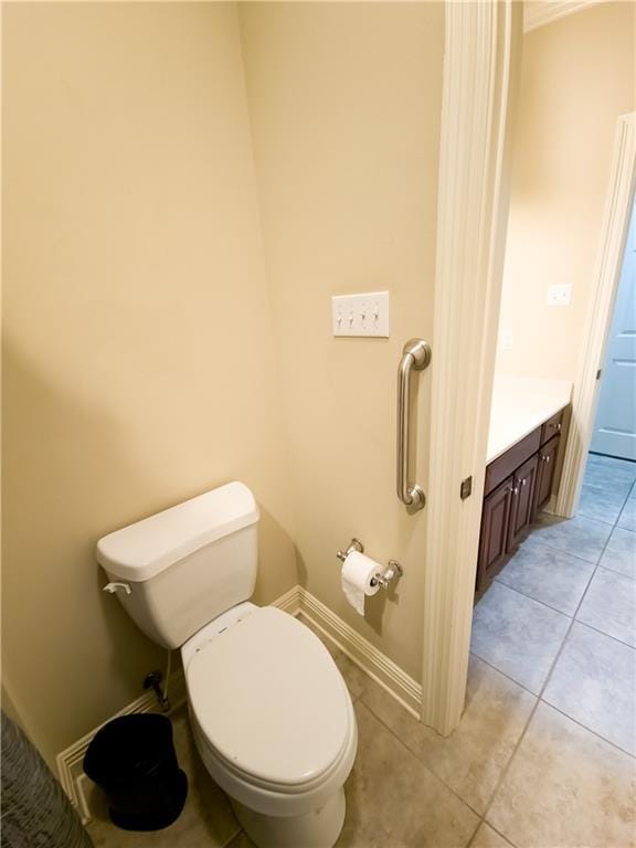 bathroom featuring tile patterned floors, vanity, and toilet