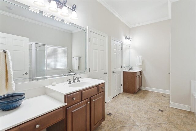 full bath featuring ornamental molding, a sink, baseboards, two vanities, and a stall shower