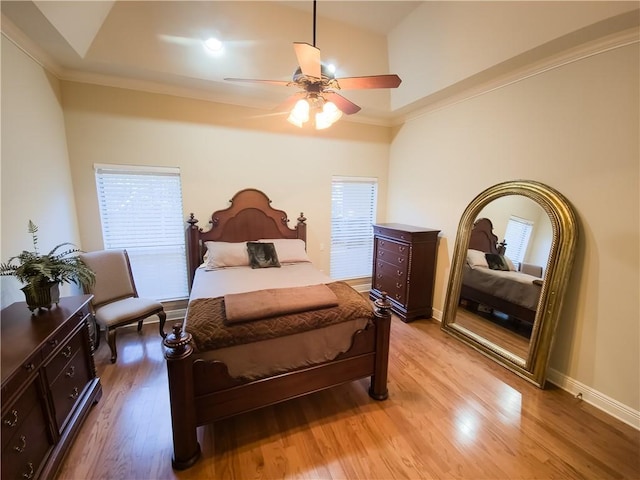 bedroom featuring ceiling fan, light hardwood / wood-style floors, and crown molding