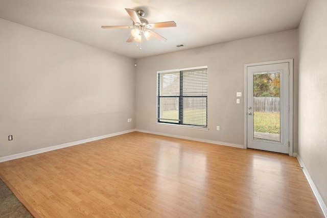 spare room with ceiling fan and light wood-type flooring