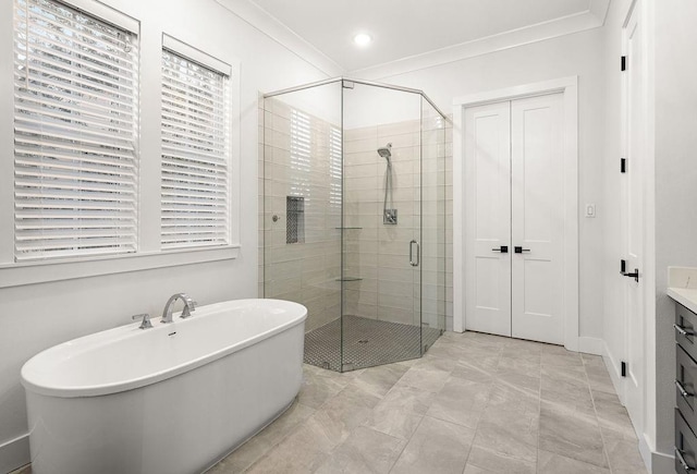 bathroom with crown molding, vanity, and separate shower and tub