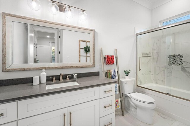 full bathroom featuring vanity, ornamental molding, enclosed tub / shower combo, and toilet