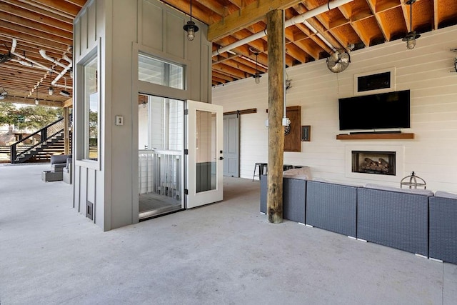 view of patio with an outdoor living space with a fireplace