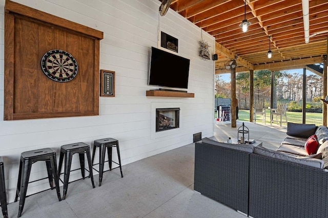 view of patio / terrace featuring exterior bar and an outdoor hangout area