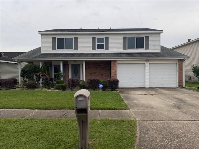 view of property with a front yard and a garage