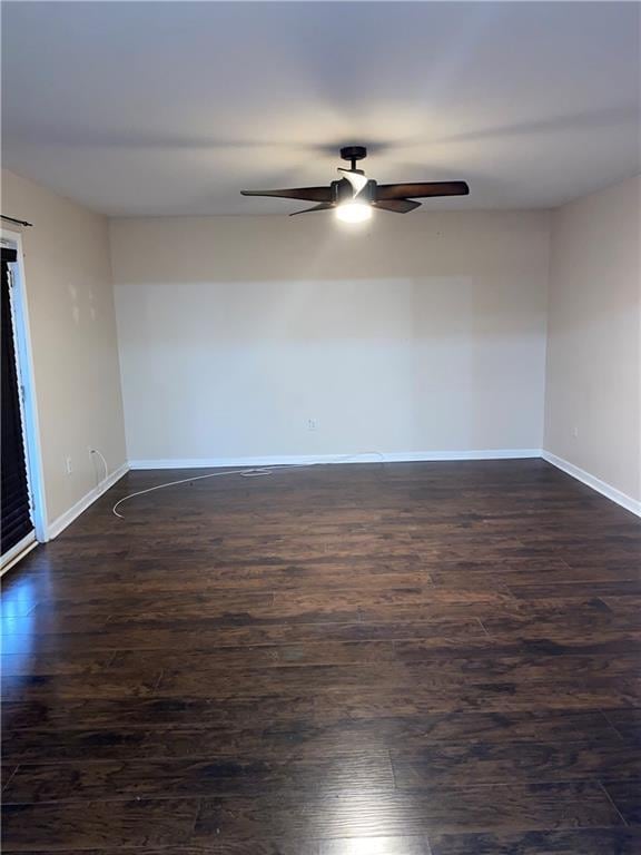 unfurnished room with ceiling fan and dark hardwood / wood-style flooring