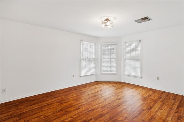 unfurnished room featuring hardwood / wood-style floors