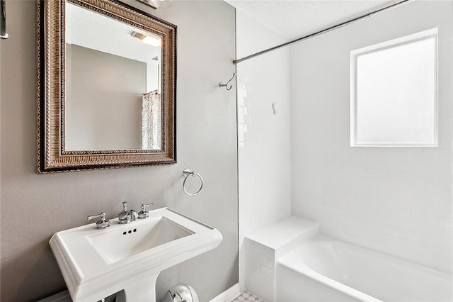 bathroom featuring a bath and sink